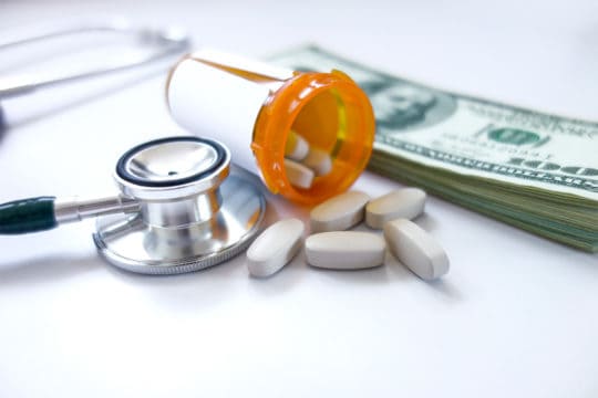 Medicine pills on dollars.