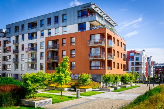 Walkway leading along the new colorful complex of apartment buildings