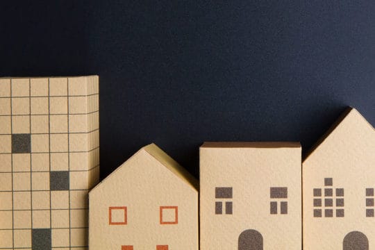 Home architectural model paper box cubes on black background