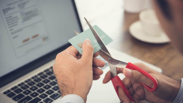 Businessman cutting a credit card