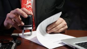 The businessman puts a stamp on the contract