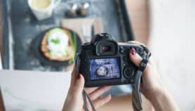 Female hands taking picture of breakfast table set up