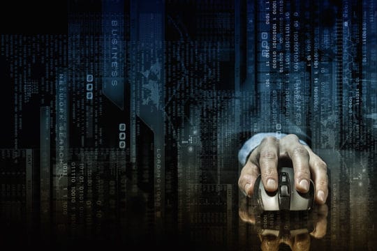 Hand of businessman in suit on dark digital background