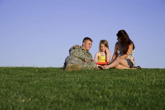 Military family sitting in a park