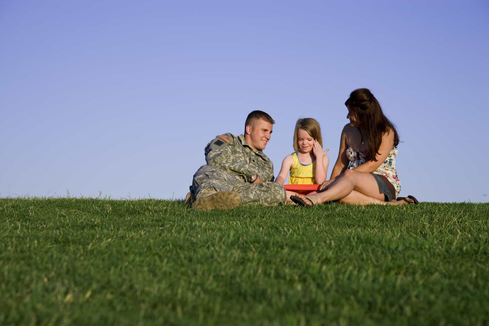 Military family sitting in a park