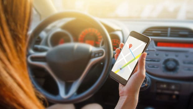 Close up hand woman using navigation or gps on mobile smartphone.