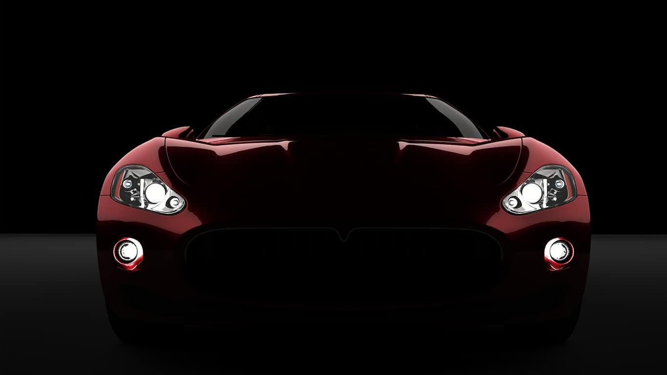Computer generated image of a luxury sports car, studio setup, dark background.