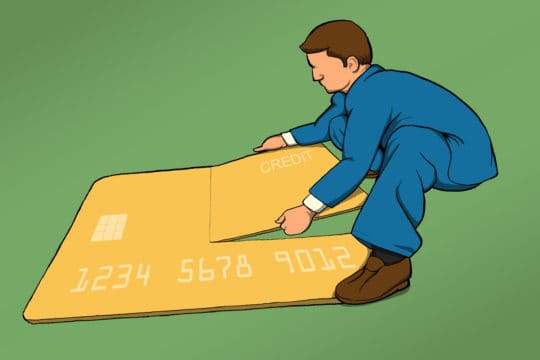 Man taking apart a large credit card puzzle (illustration)