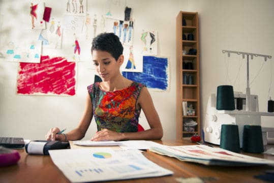 small business debt collection; business owner reviewing invoices
