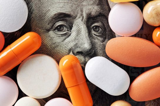 healthcare costs; image of pills on top of dollar bill
