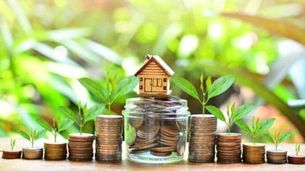 home equity loans; tiny wooden house surrounded by coins and growing plants