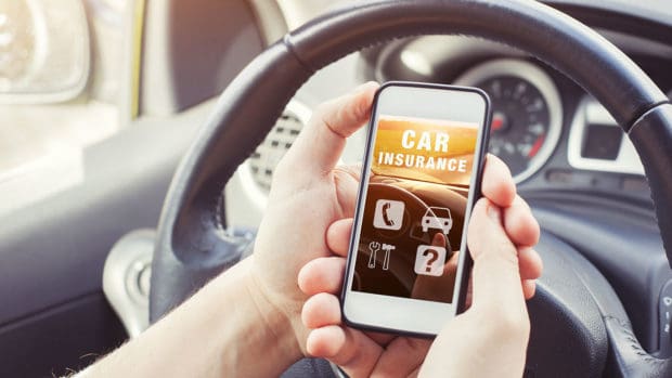 Car insurance concept, driver reading website on smartphone