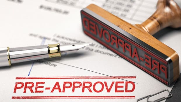 Printed document with rubber stamp and the word pre-approved