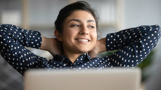 Happy satisfied Indian woman rest at home office