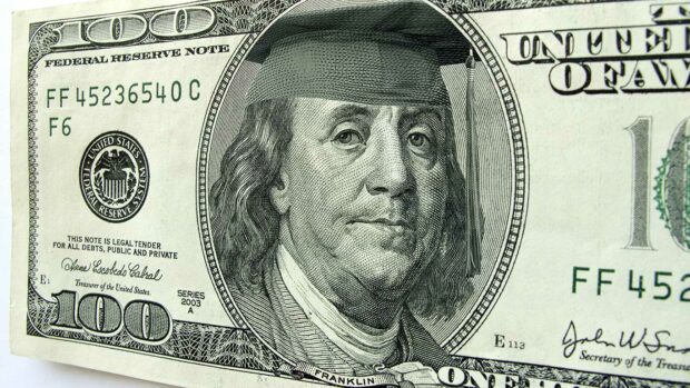 Ben Franklin wears a cap and tassel