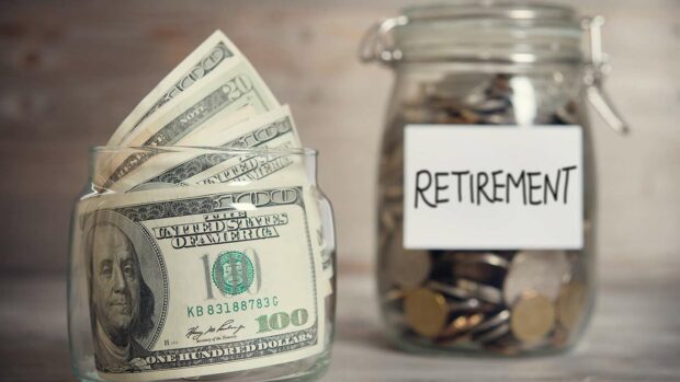 Dollars and coins in glass jar with retirement label, financial concept