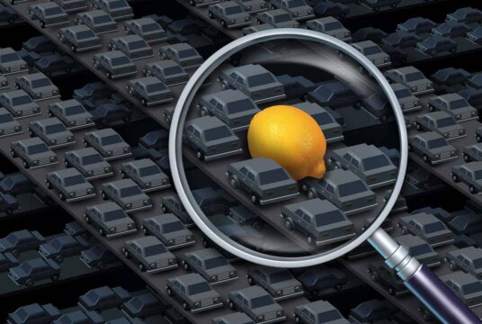 A lemon vehicle stuck in the middle of traffic with a magnifying glass enhancing the lemon between all the standard vehicles