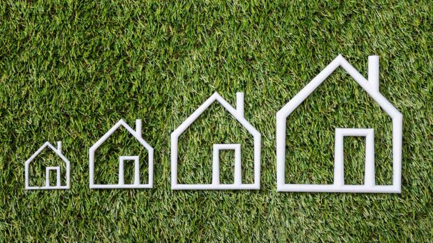 Outline Of An Increasing Size Of House On Green Grass