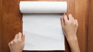 Using a paper towel on a wood surface
