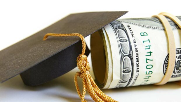 Graduation cap and cash roll, closeup