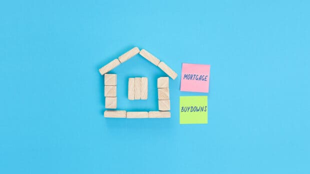 A small house made of wooden blocks and colored sticky notes with the words Mortgage buydowns.