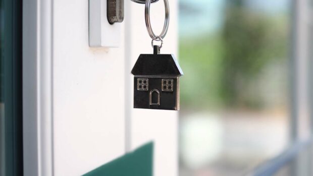 The house key for unlocking a new house is plugged into the door.