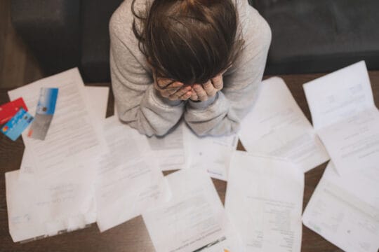 Shocked stressed young woman reading document letter from bank about loan debt financial problem, frustrated worried about bills notification, troubled with bad news or failed test results in mail