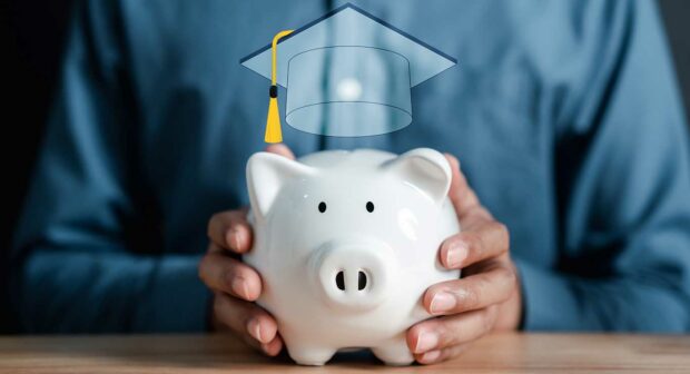 Man holding piggy bank with graduation cap. saving money for future education