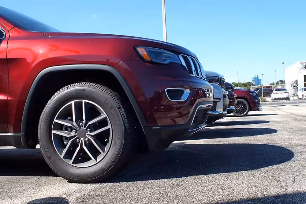 Low shot of new cars on a dealership lot
