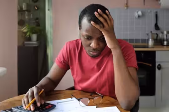 medical debt collections; stressed man looking over his medical bills