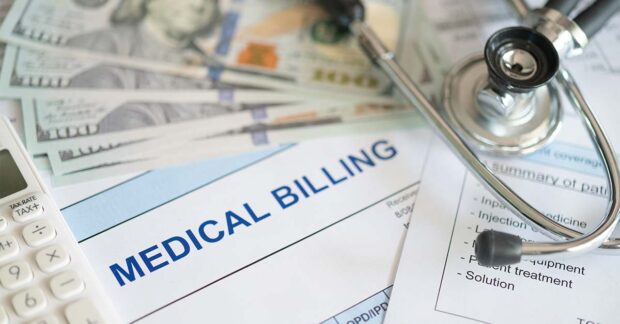 Medical billing document and dollar banknote, calculator, stethoscope. medical treatment expense concept.